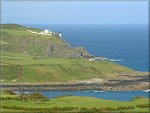 The green fields and rocky coastline around Maughold Head.